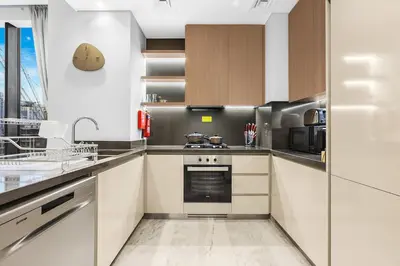 a kitchen with a sink and a stove top oven at Luxury 1BR in Business Bay with Burj Khalifa Views, Balcony, Pool and Gym Access in Dubai