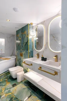a bathroom with two sinks and two mirrors at Chic City Retreat Steps from Dubai Mall & Dubai Opera in Dubai