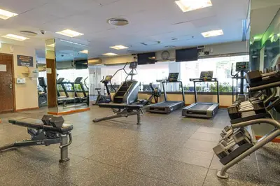 a gym with several treadmills and machines in a room at Chic City Retreat Steps from Dubai Mall & Dubai Opera in Dubai