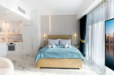 a bedroom with a bed with a blue blanket at Chic City Retreat Steps from Dubai Mall & Dubai Opera in Dubai