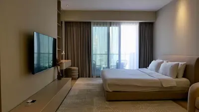 a hotel room with a bed and a flat screen tv at Cinematic View Studio - Emaar Residences in Dubai