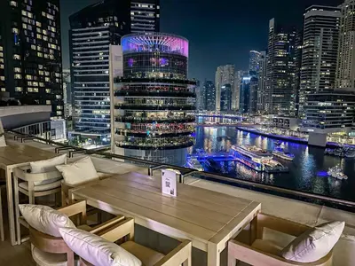 a restaurant with a view of a city at night at Cinematic View Studio - Emaar Residences in Dubai
