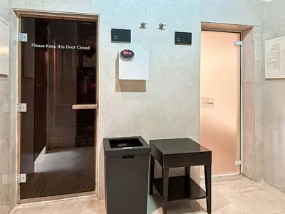 a bathroom with a trash can and a table at Cinematic View Studio - Emaar Residences in Dubai