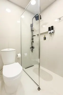 a bathroom with a toilet and a shower at Modern Studio with Balcony - Close to Metro & Marina in Dubai