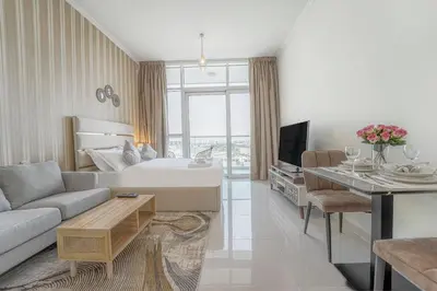 a living room with a bed and a couch at Studio in Damac H1 by Deleguest in Dubai