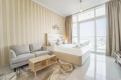 a hotel room with a bed and a couch at Studio in Damac H1 by Deleguest in Dubai