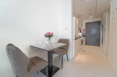 a dining room with a table and chairs at Studio in Damac H1 by Deleguest in Dubai
