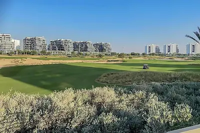 a view of a golf course with buildings in the background at Studio in Damac H1 by Deleguest in Dubai