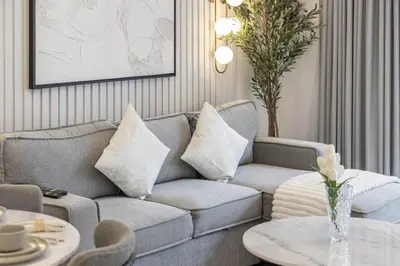 a living room with a couch and a table at Luxury Studio in Dubai Marina with Canal views in Dubai