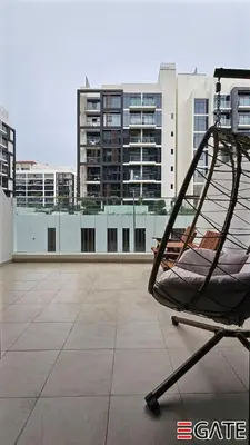a chair on the roof of a building at EGATE - Studio - 1st Floor with Terrace - Dubai - 31-109 in Dubai