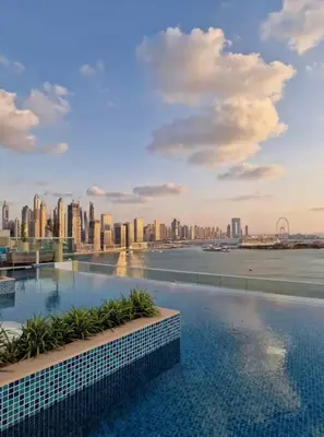 a swimming pool with a city skyline in the background at High-floor 1 Bedroom by Seven Apartments Palm Jumeirah in Dubai