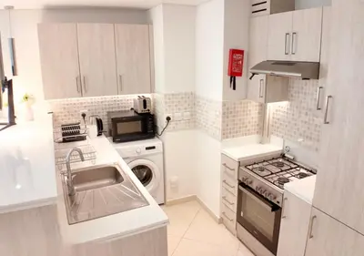 a small kitchen with a sink and a stove at High-floor 1 Bedroom by Seven Apartments Palm Jumeirah in Dubai