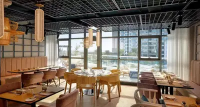a restaurant with tables and chairs and a large window at High-floor 1 Bedroom by Seven Apartments Palm Jumeirah in Dubai