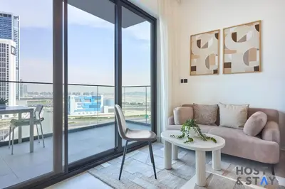 a living room with a couch and a table at Cozy Studio in Binghatti Canal - Close to Downtown in Dubai