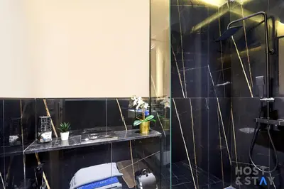 a bathroom with a shower with a sink and a toilet at Cozy Studio in Binghatti Canal - Close to Downtown in Dubai