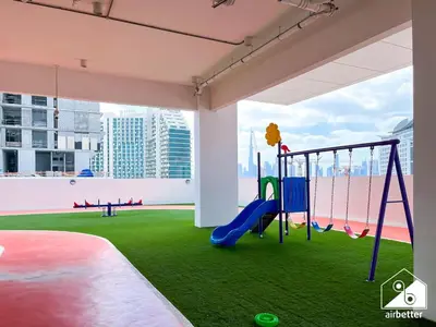 a play area with a slide and a playground at Serene Studio with Views in Al Waleed Garden 2 in Dubai