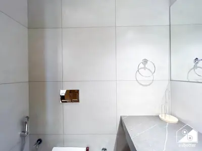 a white bathroom with a shower and a sink at Chic Comfort at oxford Residence in Dubai