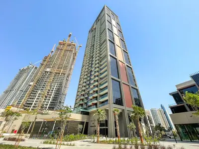 two tall buildings are under construction in a city at Luxe 2BR Retreat, Canal Views & Prime Dubai Stay Near Attractions in Dubai