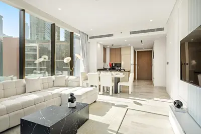 a living room with a white couch and a table at Luxe 2BR Retreat, Canal Views & Prime Dubai Stay Near Attractions in Dubai