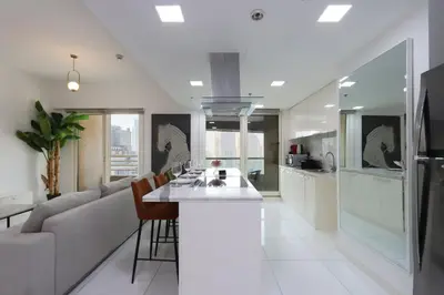 a kitchen and living room with a couch and a table at Livbnb-Upgraded 3B with Marina View,Near Promenade in Dubai
