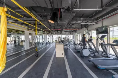 a gym with treadmills ellipticals and exercise bikes at Fresh & Stylish 2br Living At Collective Tower 1 in Dubai