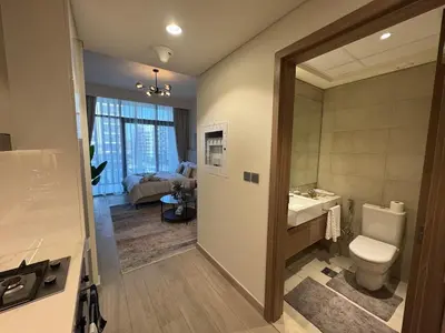 a bathroom with a toilet and a sink and a mirror at Amazing Studio for Rent in Dubai