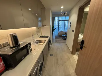a kitchen with a sink and a counter with a dishwasher at Amazing Studio for Rent in Dubai