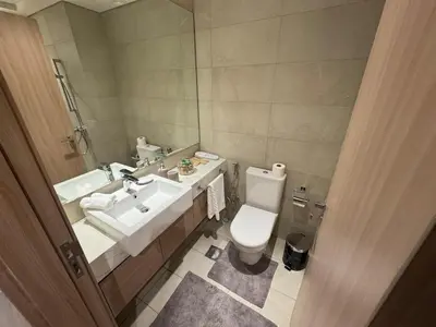 a bathroom with a toilet and a sink and a mirror at Amazing Studio for Rent in Dubai