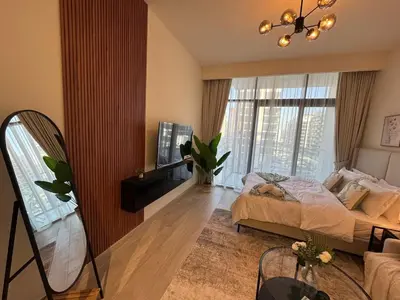 a bedroom with a bed and a large window at Amazing Studio for Rent in Dubai