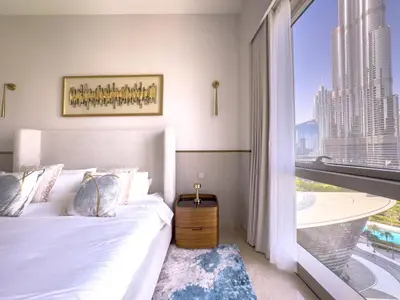 a bedroom with a bed and a large window at GRANDE SIGNATURE with a direct Burj Khalifa view and Private Fountain Show with DXB AIRPORT VIP Shuttle option for 8 guests in Dubai