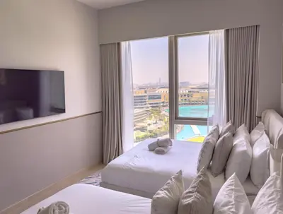 a hotel room with two beds and a large window at GRANDE SIGNATURE with a direct Burj Khalifa view and Private Fountain Show with DXB AIRPORT VIP Shuttle option for 8 guests in Dubai