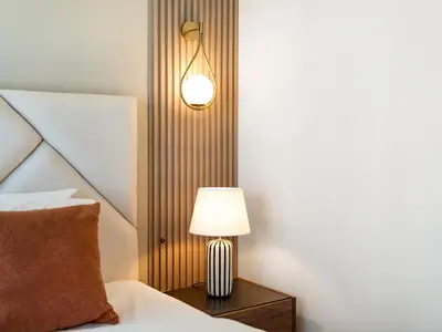 a lamp on a night stand next to a bed at Panoramic Burj Khalifa Views at Burj Royale by Propigo in Dubai