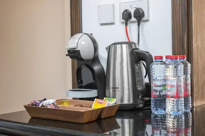 a coffee maker and bottles of water on a counter at Luxe Marina View Retreat! 2BDRM in Dubai