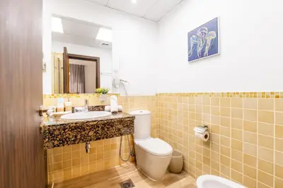 a bathroom with a sink and a toilet and a mirror at Luxe Marina View Retreat! 2BDRM in Dubai