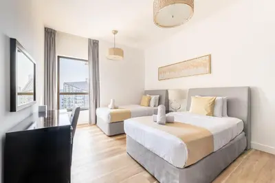 a hotel room with two beds and a couch at Luxe Marina View Retreat! 2BDRM in Dubai