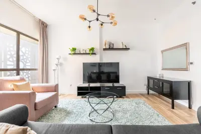 a living room with a couch and a flat screen tv at Luxe Marina View Retreat! 2BDRM in Dubai