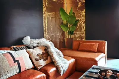 a living room with a couch and a chair at Black & Bold - Aesthetic Stay in Dubai