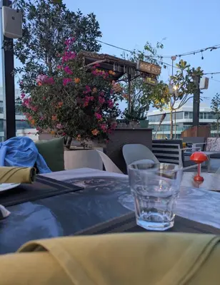 a table with a glass on top of a table at Stylish Urban-Jungle-Studio in Al Barari, Dubai in Dubai