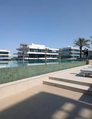two benches sitting on a sidewalk in front of a building at Stylish Urban-Jungle-Studio in Al Barari, Dubai in Dubai