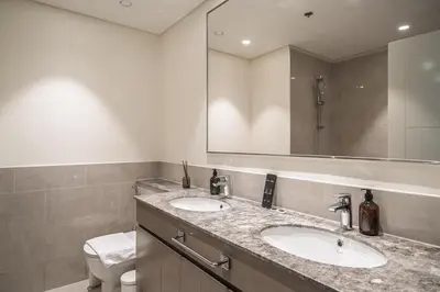 a bathroom with two sinks and a mirror at KING 2BR LUX Apt-5mins Dubai Mall-Downtown Dubai in Dubai