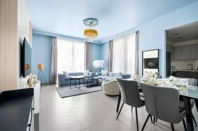 a dining room and living room with a table and chairs at KING 2BR LUX Apt-5mins Dubai Mall-Downtown Dubai in Dubai