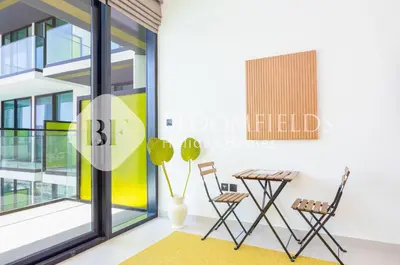 a room with a table and chairs in a building at Bloomfields Amber Horizon Stu Binghatti in Dubai