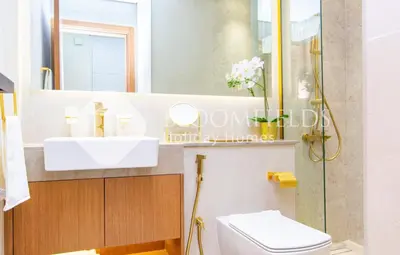 a bathroom with a sink and a toilet and a mirror at Bloomfields Amber Horizon Stu Binghatti in Dubai