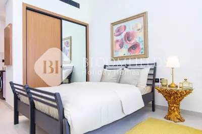 a bedroom with a large bed and a table at Bloomfields Amber Horizon Stu Binghatti in Dubai