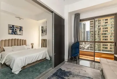 a bedroom with a large bed and a large window at Ahlan Furnished Full Apartment Marina Cityview JBR Beach for Families in Dubai