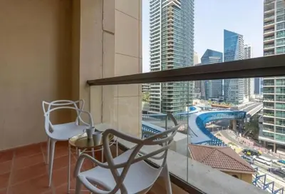 a balcony with two chairs and a view of a city at Ahlan Furnished Full Apartment Marina Cityview JBR Beach for Families in Dubai