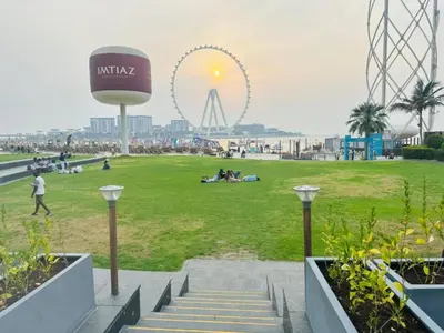 a park with a ferris wheel in the background at Ahlan Furnished Full Apartment Marina Cityview JBR Beach for Families in Dubai