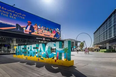 a large sign in the middle of a city at Ahlan Furnished Full Apartment Marina Cityview JBR Beach for Families in Dubai