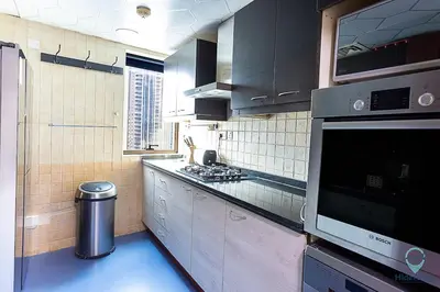 a kitchen with black cabinets and a stove top oven at 2BR Breathtaking Waterfront Heart of Marina in Dubai