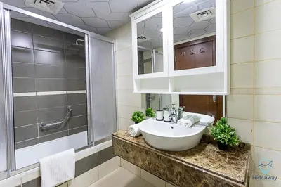 a bathroom with a sink and a shower at 2BR Breathtaking Waterfront Heart of Marina in Dubai